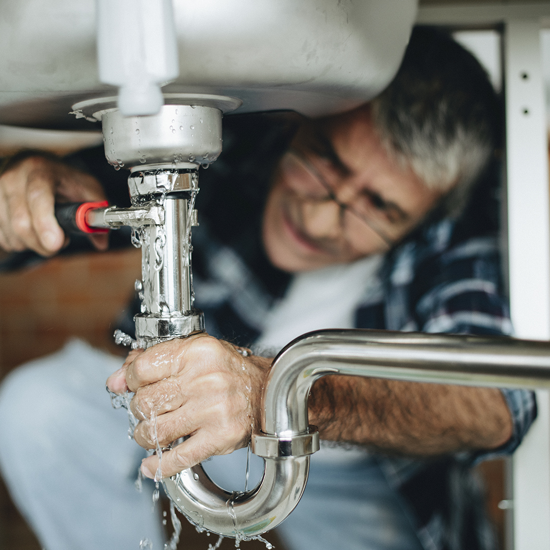 Plumber fixing the kitchen sink